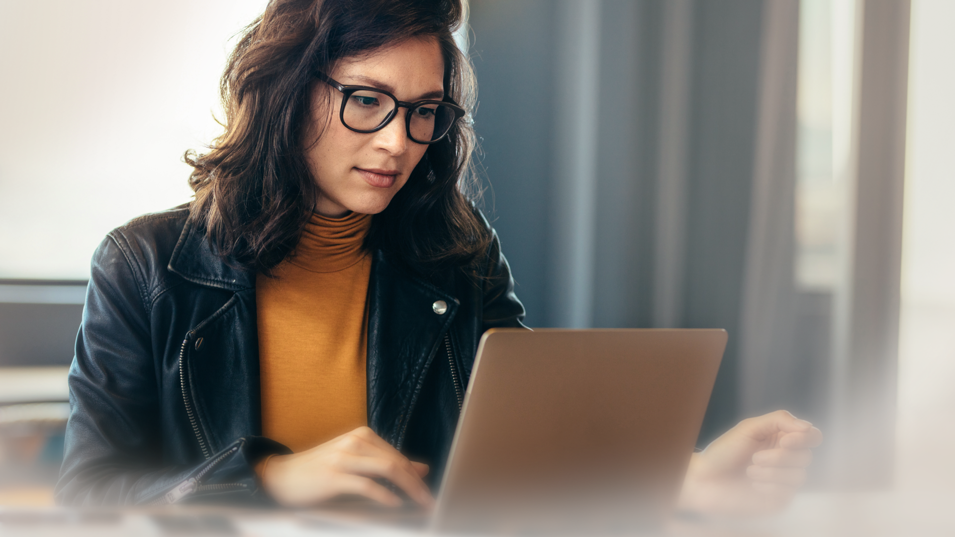 Image of a woman working on her laptop